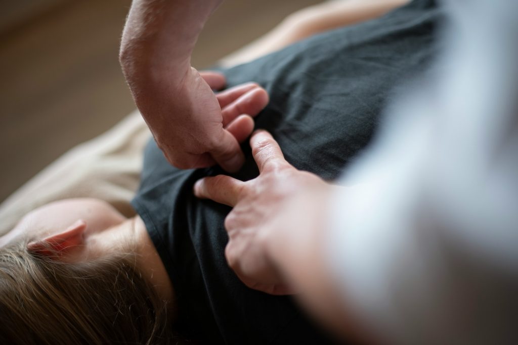 Sports massage helping an office worker relieve muscle tension